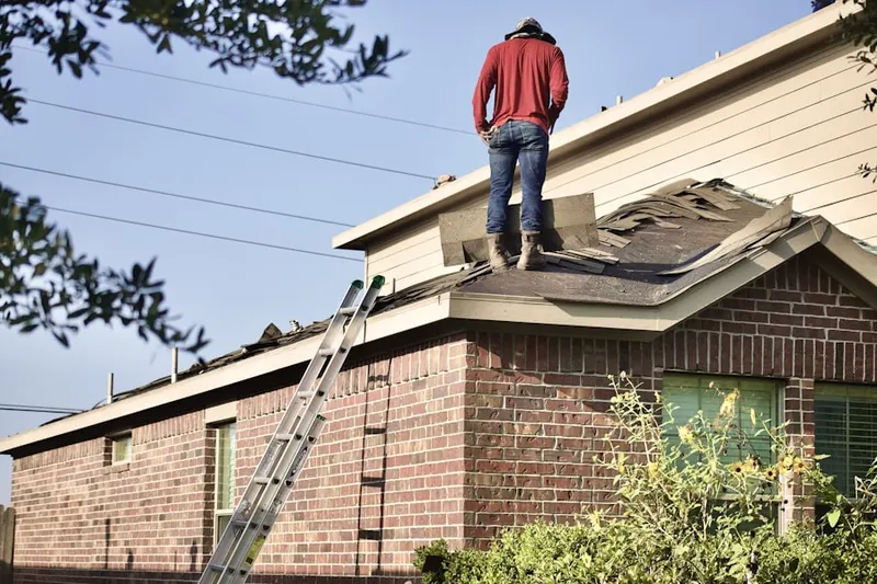Professional roofer working on a residential roof in Downtown Burleson